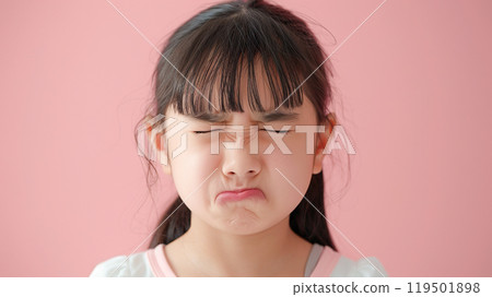 Girl grimacing unhappy on pink background 119501898