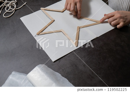 Christmas star ice cream sticks handmade Storytelling creating craft Christmas holiday decoration. Tactile hand-on activity. Master class progress of creative me-made gifts. Seasonal domestic life 119502225