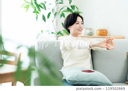 Woman relaxing in the living room Woman relaxing in the living room 119502669