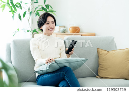 操作遙控器的女人 119502739