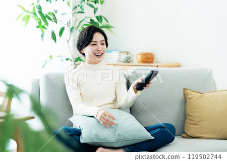 A woman who operates a remote control A woman who operates a remote control 119502744