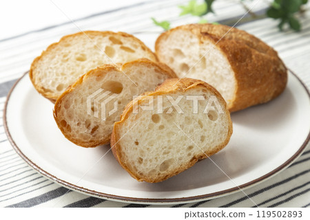 Cut baguette on a white background Cut baguette on a white background 119502893