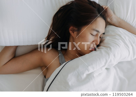 Woman sleeping on white bed, wake up late. Woman sleeping on white bed, wake up late. 119503264