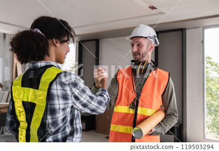 Engineering Team Celebrates Successful Project Completion with Handshake in Modern Office Environment 119503294