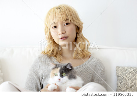 Living with a cat: A woman holding a cat 119503333