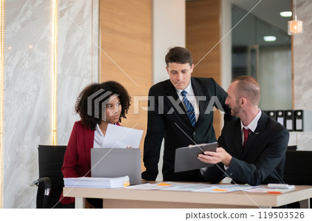 Diverse business team discussing project at office desk, Concept of teamwork 119503526