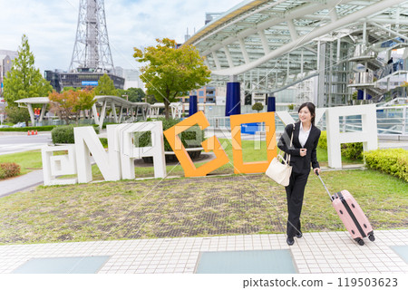 A young businesswoman pulling a suitcase on a business trip to Nagoya A young businesswoman pulling a suitcase on a business trip to Nagoya 119503623