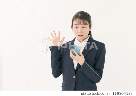 A woman with a suit with a smartphone A woman with a suit with a smartphone 119504185