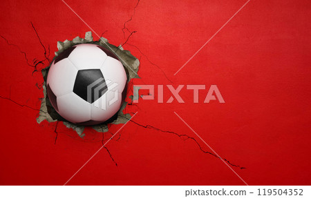 Soccer ball breaks through red concrete wall, concept of power, strength. Soccer ball breaks through red concrete wall, concept of power, strength. 119504352