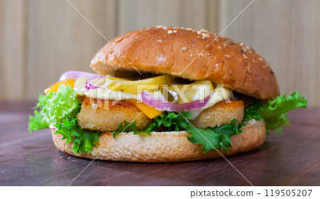Delicious tasty burger with chicken cutlet, vegetables and cheese Delicious tasty burger with chicken cutlet, vegetables and cheese 119505207