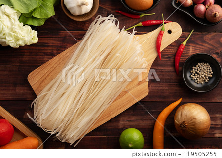 Dry instant small noodle,Thai thin rice stick noodles in wooden plate.Top view. 119505255