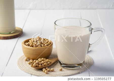 Soy milk in glass and grains soy bean on white table,Alternative milk,healthy concept. Soy milk in glass and grains soy bean on white table,Alternative milk,healthy concept. 119505277