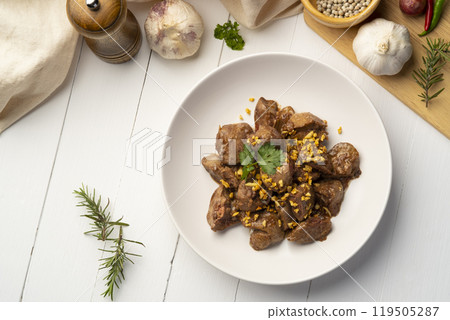 Fried chicken Liver with Garlic,Stir fry sliced liver with peppercorn and garlic in white plate.Top view Fried chicken Liver with Garlic,Stir fry sliced liver with peppercorn and garlic in white plate.Top view 119505287