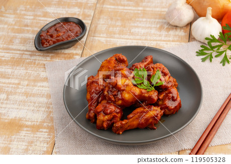 New orleans Marinated chicken wing stick on black plate.sweet and spicy. 119505328
