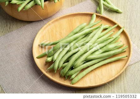 Common bean,Bush beans are french green beans in wooden plate. 119505332