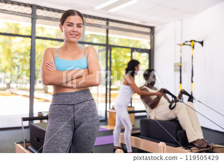 Portrait of smiling woman posing in fitness studio Portrait of smiling woman posing in fitness studio 119505429