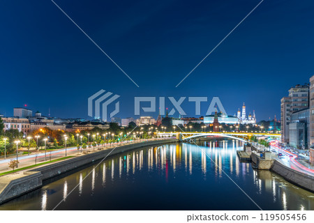 Illuminated Moscow Kremlin and Bolshoy Kamenny Bridge at summer night. View from the Patriarshy pedestrian Bridge 119505456