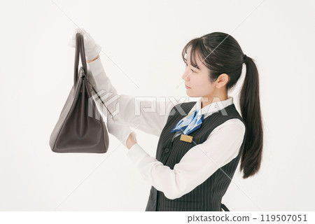A female staff member appraising a used bag A female staff member appraising a used bag 119507051