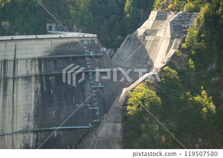 Kurobe Dam, Tateyama, Toyama, Chubu, Japan A concrete dam shows signs of wear, with a heavily eroded section and surrounding greenery 119507580