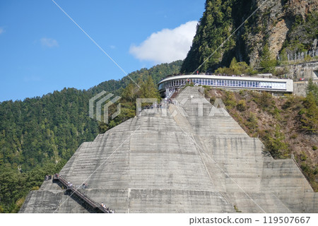 Kurobe Dam, Tateyama, Toyama, Chubu, Japan A scenic view of a terraced mountain structure with greenery and a pathway Kurobe Dam, Tateyama, Toyama, Chubu, Japan A scenic view of a terraced mountain structure with greenery and a pathway 119507667
