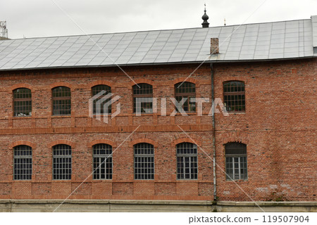 Old red brick building facade 119507904
