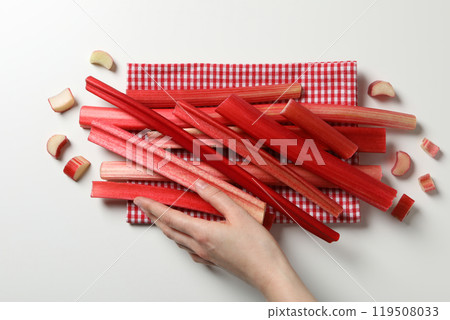 Ripe stalks of rhubarb on a light background Ripe stalks of rhubarb on a light background 119508033