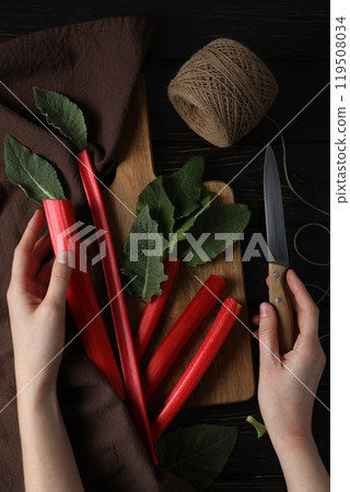 Fresh stalks of rhubarb on a dark background Fresh stalks of rhubarb on a dark background 119508034