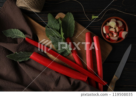 Fresh stalks of rhubarb on a dark background 119508035