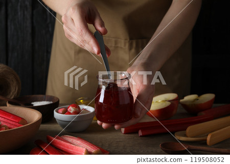 A jar of jam with fresh rhubarb stems 119508052