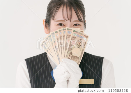 A woman in white gloves hiding her face with a banknote 119508338