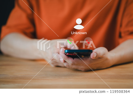 Man answering the incoming call. The phone call was from an unknown number. Hoax person with a fake identity. Call center gang or stranger. Concept of scam, fraud with a smartphone from the criminal. 119508364