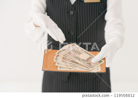 Woman in white gloves handing over money 119508812