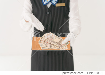 Woman in white gloves handing over money 119508813