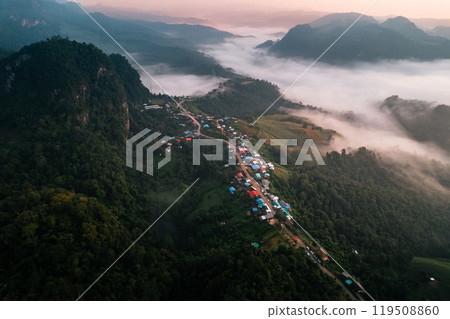 Aerial view of Morning fog and mountains with a rural village and sunrise from above Aerial view of Morning fog and mountains with a rural village and sunrise from above 119508860