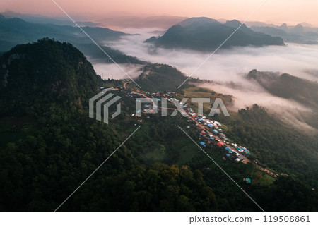 Aerial view of Morning fog and mountains with a rural village and sunrise from above 119508861