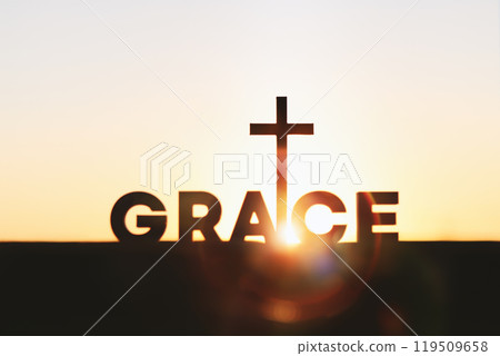 Bright rising new year sunrise beautiful sun light and holy cross of jesus christ, grace word GRACE background 119509658