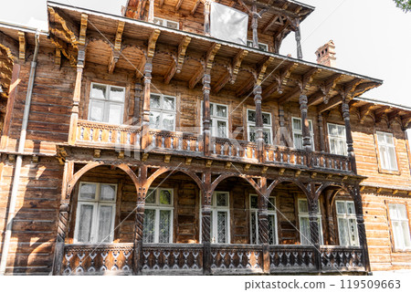 Wooden house. Windows and balcony of an old building. 119509663