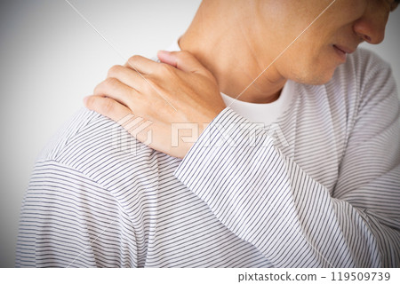 Middle-aged man suffering from stiff shoulders Middle-aged man suffering from stiff shoulders 119509739