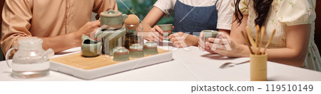 Family Drinking Tea At The Table 119510149