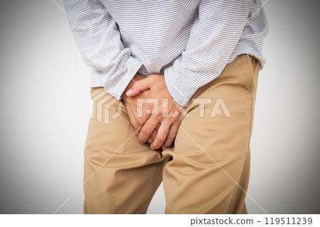 Middle-aged man holding his crotch 119511239