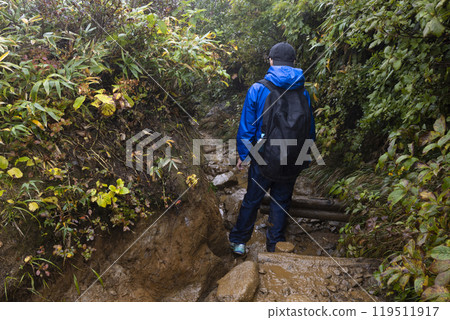 A boy climbing a mountain 119511917