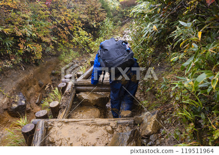 A boy climbing a mountain A boy climbing a mountain 119511964