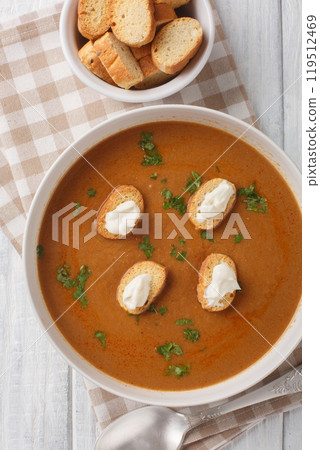 Soupe de poisson French soup made with fresh fish with croutons and aioli sauce closeup on the bowl. Vertical top view 119512469