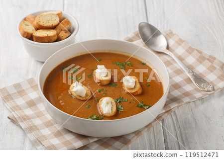 Homemade Soupe de poisson thick and hearty soup has a delicate flavor with a gentle fish undertone with croutons and aioli sauce closeup on the bowl. Horizontal Homemade Soupe de poisson thick and hearty soup has a delicate flavor with a gentle fish undertone with croutons and aioli sauce closeup on the bowl. Horizontal 119512471
