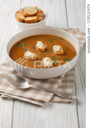 Soupe de poisson French soup made with fresh fish with croutons and aioli sauce closeup on the bowl. Vertical 119512474