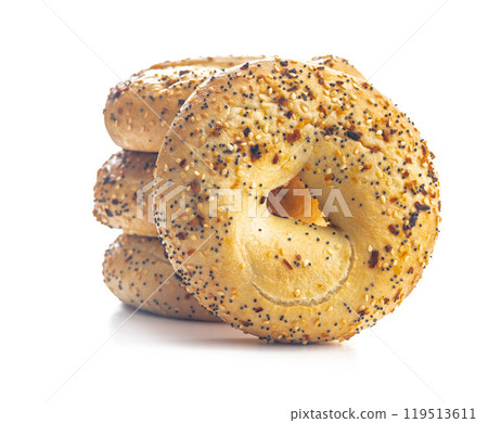 Bagel sprinkled with fried onion, sesame and poppy seeds isolated on white background. Bagel sprinkled with fried onion, sesame and poppy seeds isolated on white background. 119513611