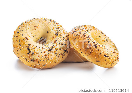 Bagel sprinkled with fried onion, sesame and poppy seeds isolated on white background. 119513614