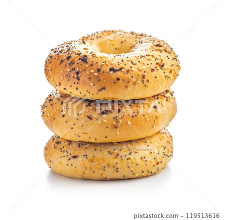 Bagel sprinkled with fried onion, sesame and poppy seeds isolated on white background. Bagel sprinkled with fried onion, sesame and poppy seeds isolated on white background. 119513616