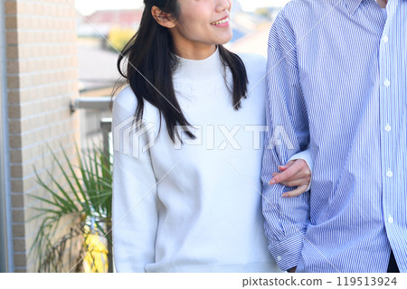 Smiling Asian couple (lovers) talking outdoors 119513924