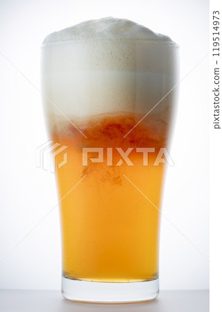 Cold delicious beer poured into a glass Cold delicious beer poured into a glass 119514973
